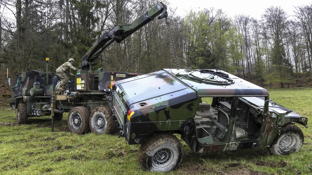 Soldiers lift a Humvee while conducting a vehicle recovery exercise during Saber Junction 17 at the Army Training Command’s Hohenfels Training Area, Germany, April 27, 2017. The exercise, which includes about 4,500 participants from 13 NATO and European partner nations, assesses the readiness of the regiment to conduct unified land operations. Army photo by Spc. Danielle Carver