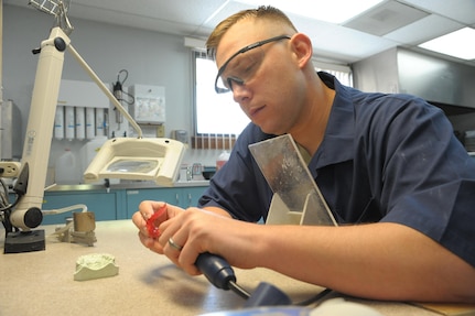 Staff Sgt. Matthew Garcia, 359th Aerospace Medicine Sq., lab technician, works on a orthopedic retainer at Joint Base San Antonio-Randolph Dental clinic, April 25, 2017.  Dental Laboratory specialists assist dentists by crafting and creating custom dental prostheses. These highly skilled experts use the latest tools and techniques and work with dental materials such as acrylic, gypsum and gold to make precision pieces for their patients that they’ll utilize for years to come.  
