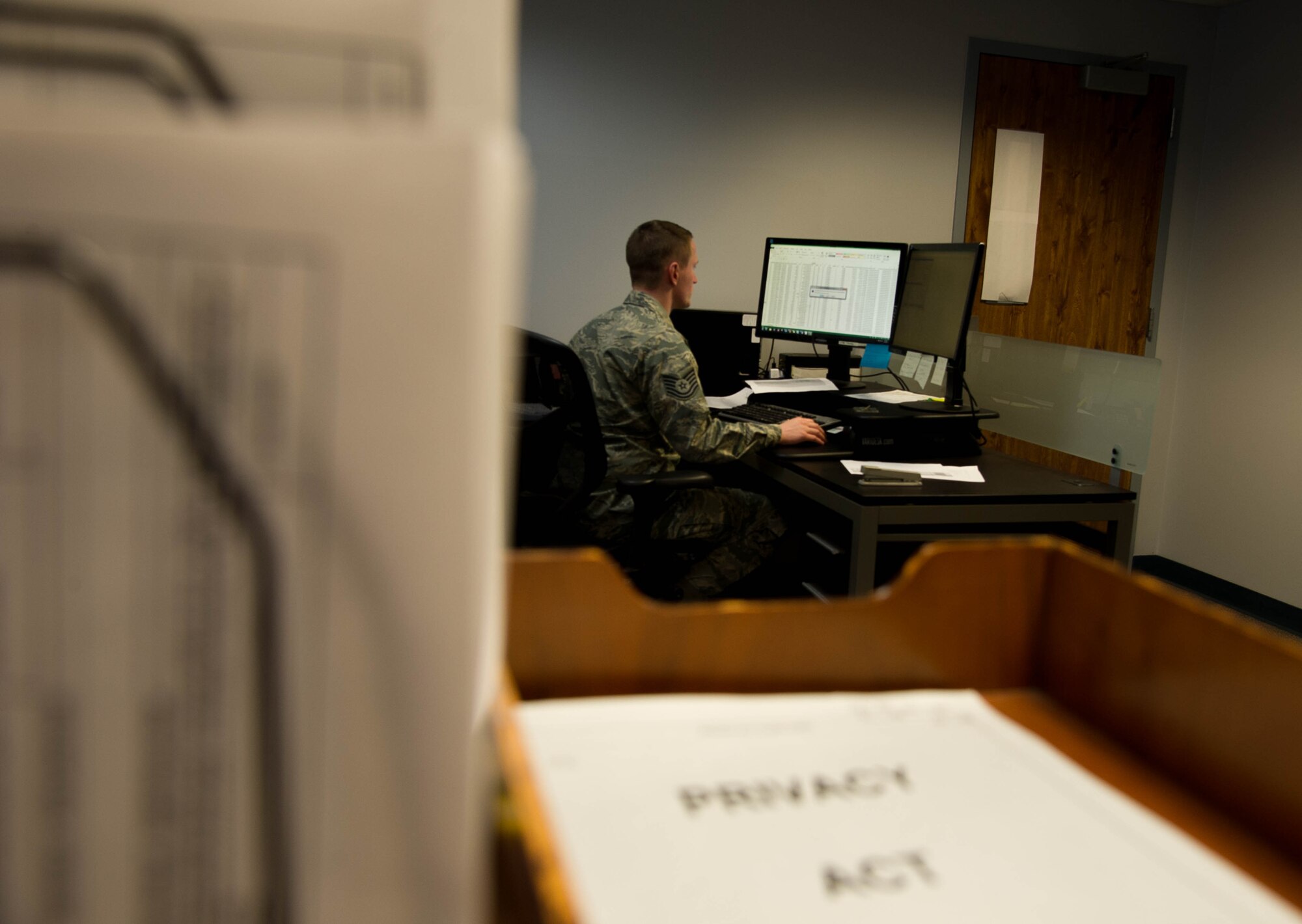 Tech. Sgt. Jesse Hughes sits at his desk in the 446th Airlift Wing Financial Management Office on Joint Base Lewis-McChord, Wash., on April 24, 2017. Financial Management has started using eFinance in order to pay travel vouchers for longer temporary duty assignments. (U.S. Air Force photo by David L. Yost)