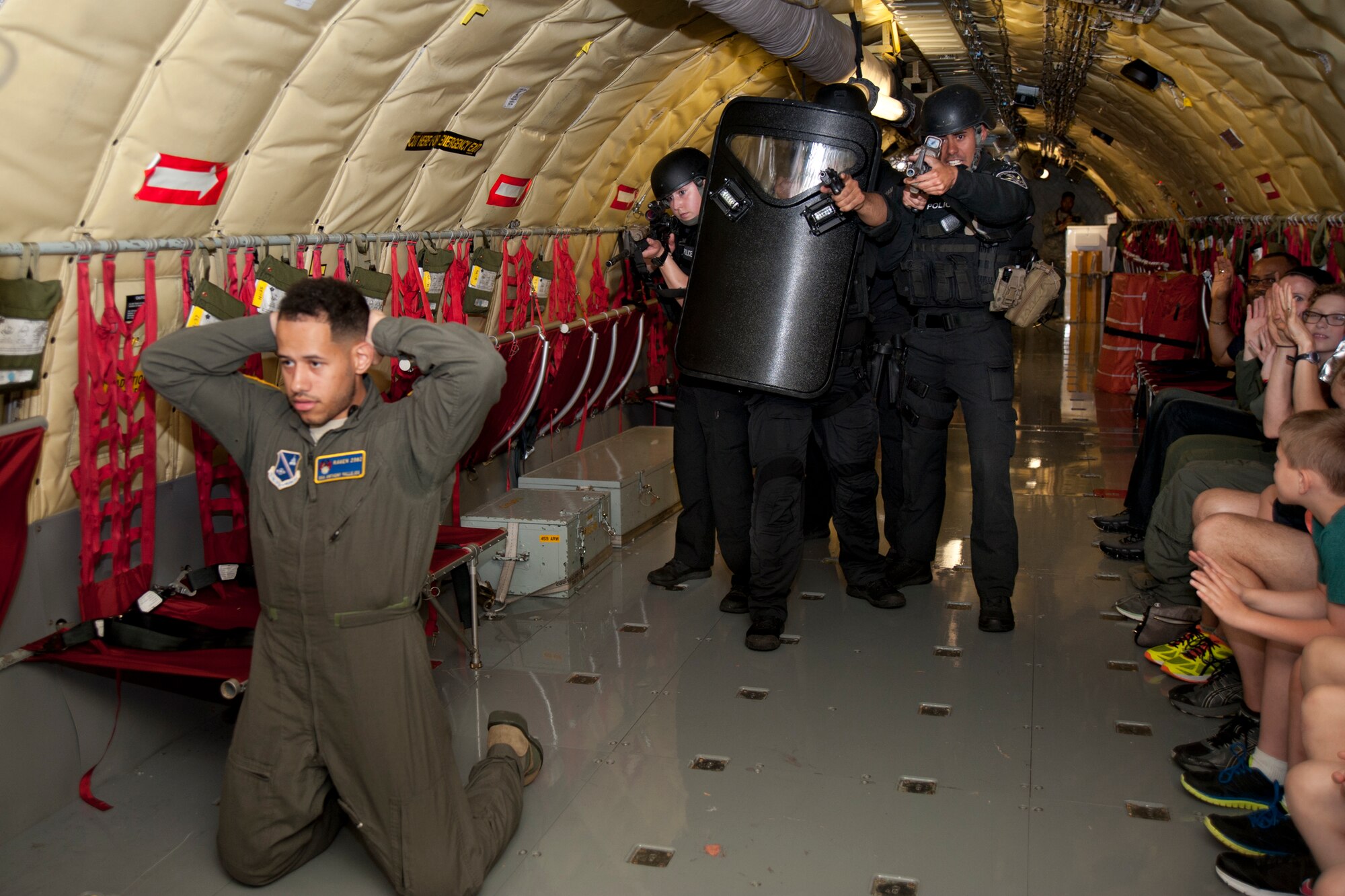 Members with 11th Wing Security Forces Squadron perform a tactical demonstration aboard a KC-135R Stratotanker April 28, 2017, at Joint Base Andrews, Maryland. The demonstration was part of the Pilot for a Day program which grants children who are diagnosed with cancer the experience of being an aviator for a day. 