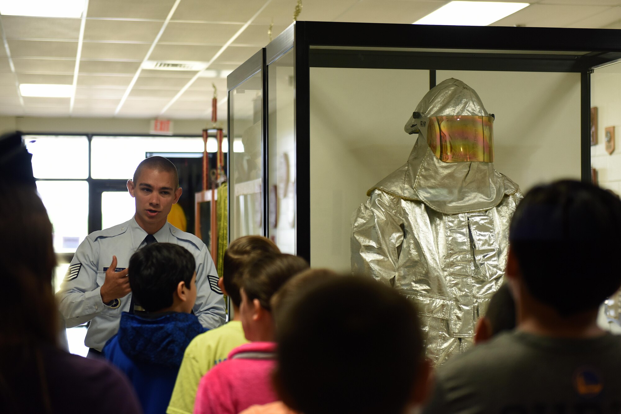 U.S. Air Force Tech. Sgt. Anthony Stanchfield, 312th Training Squadron instructor, tells Holliman guides children through the Louis F. Garland Department of Defense Fire Academy on Goodfellow Air Force Base, Texas, April 28, 2017. Stanchfield told the students about the importance of fire protection gear. (U.S. Air Force photo by Airman 1st Class Caelynn Ferguson/ Released)