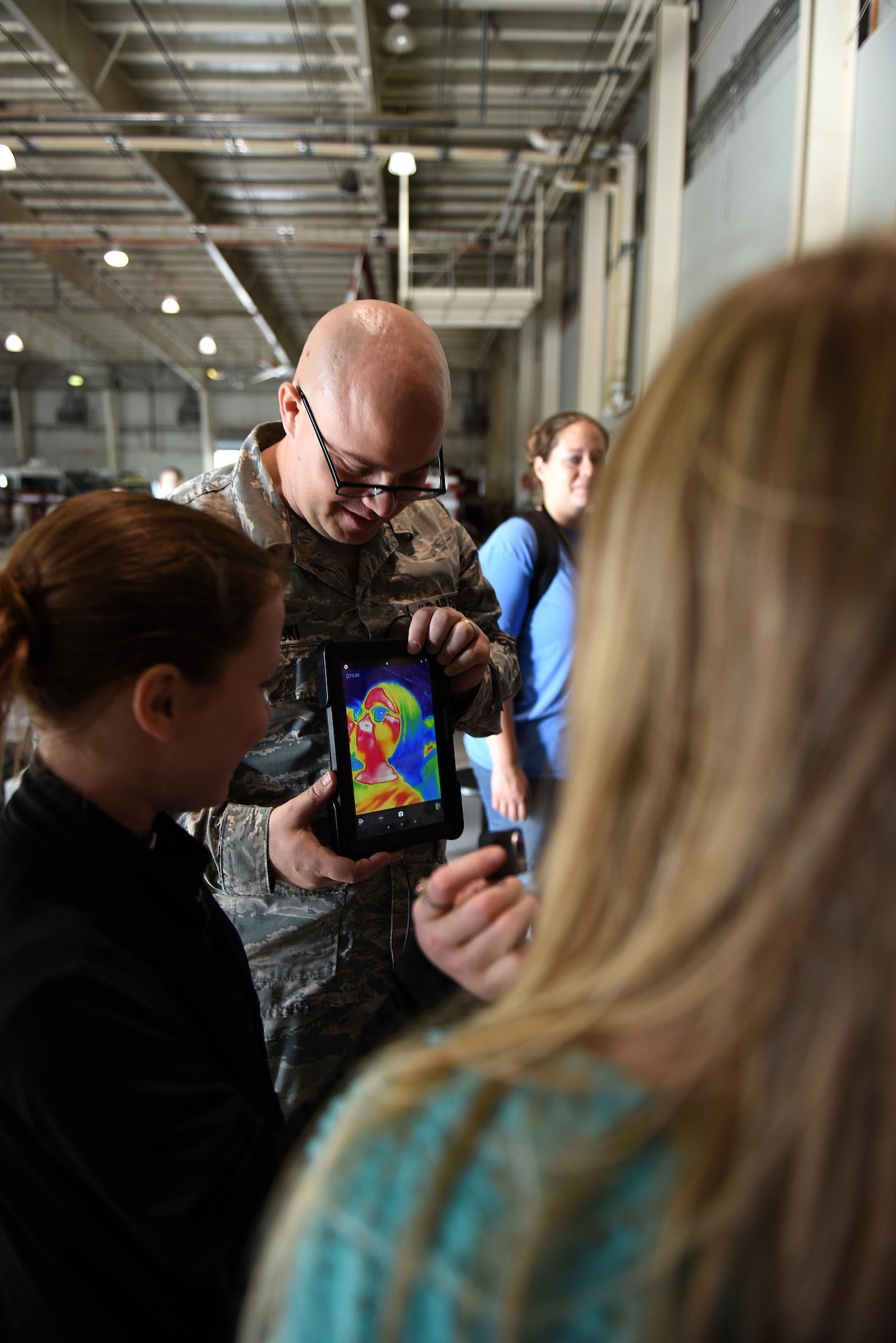 Staff Sgt. Robert Kedrowski, 312th Training Squadron course development specialist, shows thermal technology to children during the Childs Tour at the Louis F. Garland Department of Defense Fire Academy on Goodfellow Air Force Base, Texas, April 28, 2017. Kedrowski showed them that certain objects may make our hands colder and explained the uses of thermal technology. (U.S. Air Force Caelynn Ferguson/ Released)