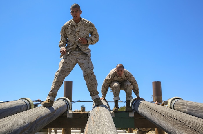 Recruits from Delta Company, 1st Recruit Training Battalion, maneuver over high logs during Obstacle Course II at Marine Corps Recruit Depot San Diego, April 20. The recruits were taught various techniques to assist them in completing the obstacles, which tested their upper and lower body strength. Annually, more than 17,000 males recruited from the Western Recruiting Region are trained at MCRD San Diego. Delta Company is scheduled to graduate June 30.