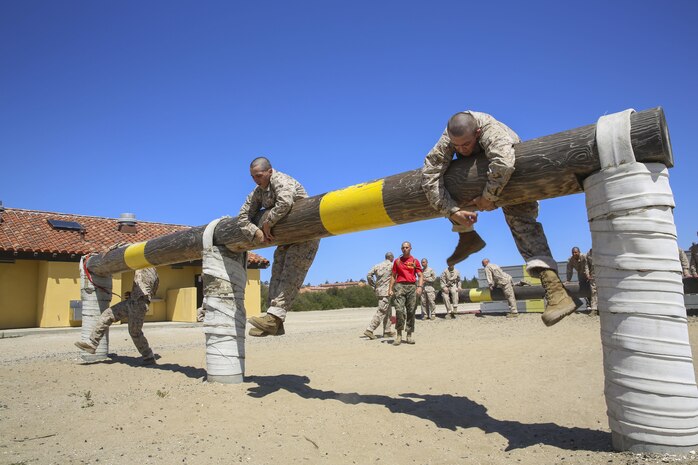 Recruits from Delta Company, 1st Recruit Training Battalion, maneuver over high logs during Obstacle Course II at Marine Corps Recruit Depot San Diego, April 20. If a recruit failed to complete an obstacle the first time, he was sent back to try it again. Annually, more than 17,000 males recruited from the Western Recruiting Region are trained at MCRD San Diego. Delta Company is scheduled to graduate June 30.