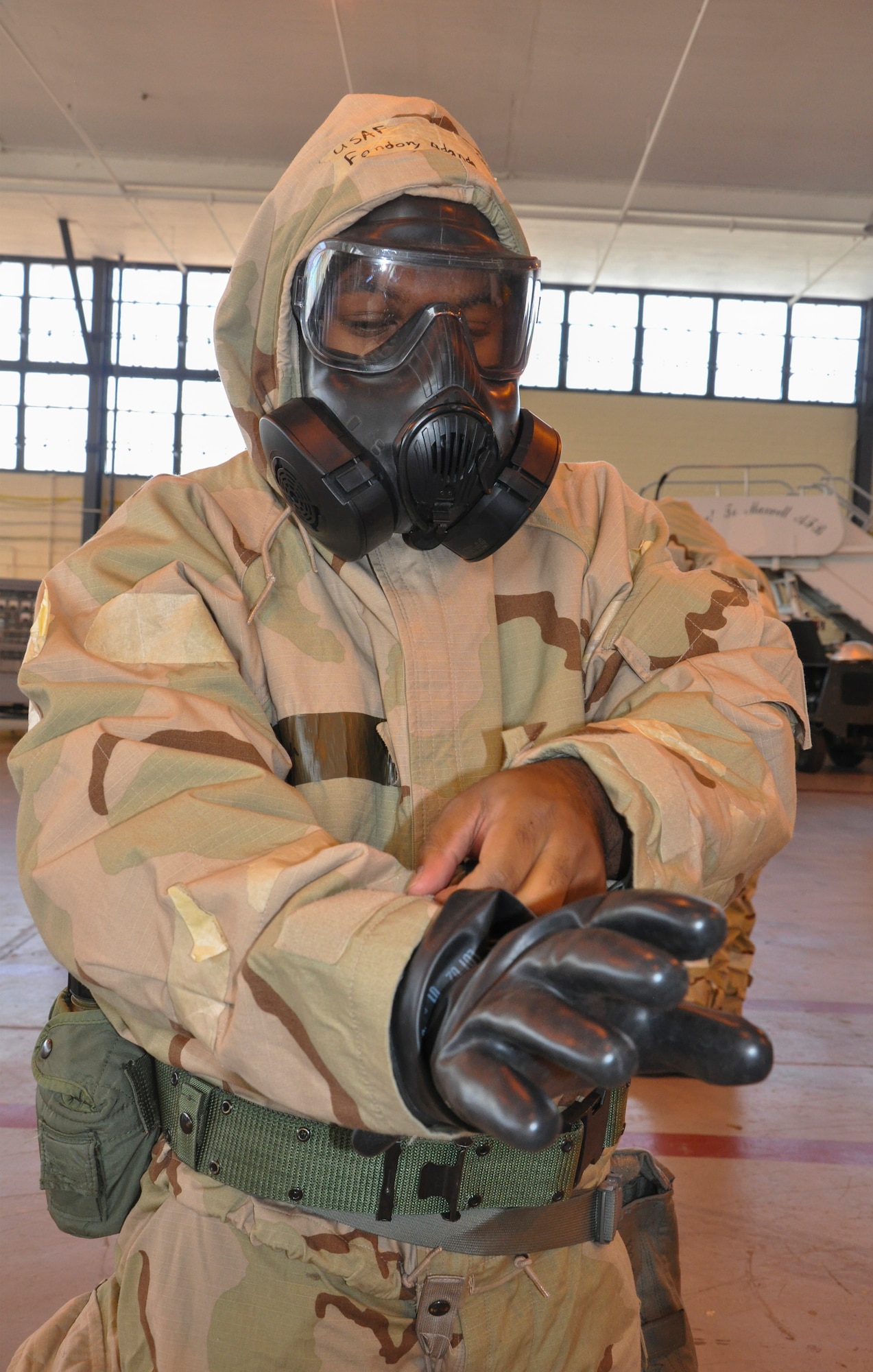 Staff Sgt. Adonda Fondon with the 908th Logistics Readiness Squadron, puts on level 4 mission-oriented protective posture gear during the Basic Deployment Readiness Rodeo March 4, at Maxwell Air Force Base, Ala. The BDR Rodeo was a three day readiness training where Air Force personnel practiced a number of predeployment activities to include Chemical, Biological, Radioactive, and Nuclear preparedness training. (U.S. Air Force photo by Staff Sgt. Malia Belton)