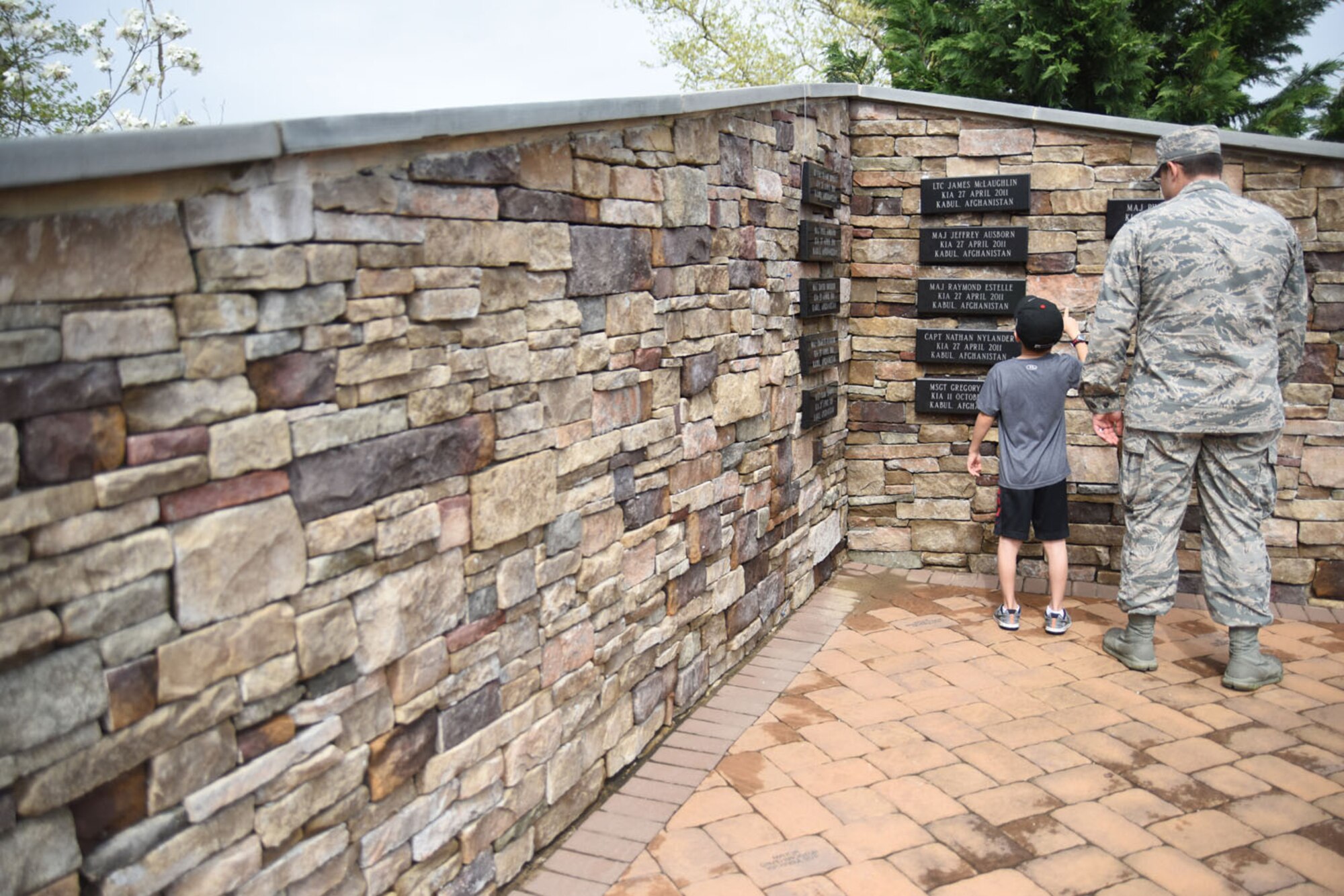 Attendees view the names of the fallen on the Air Advisor Memorial wall following the memorial ceremony, at Joint Base McGuire-Dix-Lakehurst, New Jersey, April 27, 2017.(U.S. Air Force photo/Brad Camara)