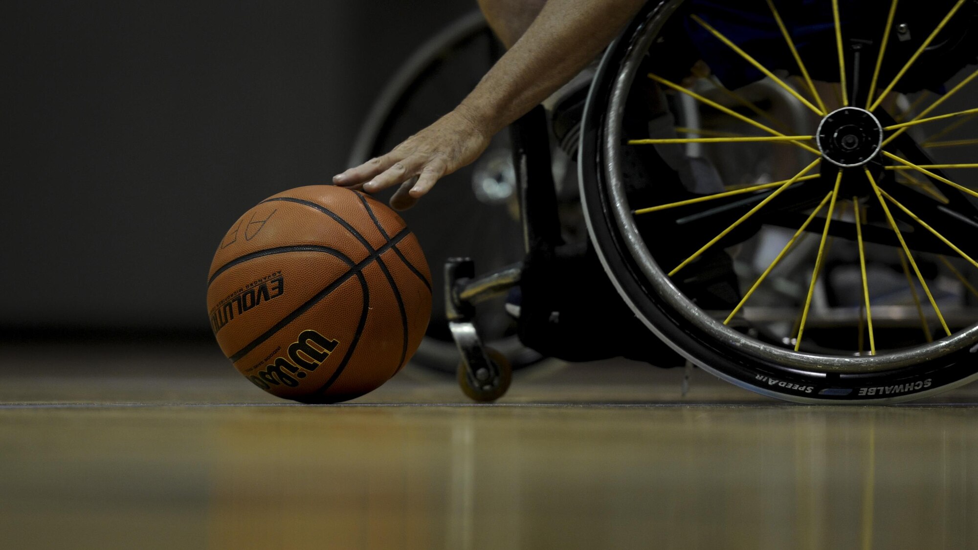 Jerry Terry, the assistant coach of the Air Force wheelchair basketball team, picks up a basketball during practice at Hurlburt Field, Fla., April 24, 2017. This Terry’s first year coaching with the team. (U.S. Air Force photo by Airman 1st Class Dennis Spain)