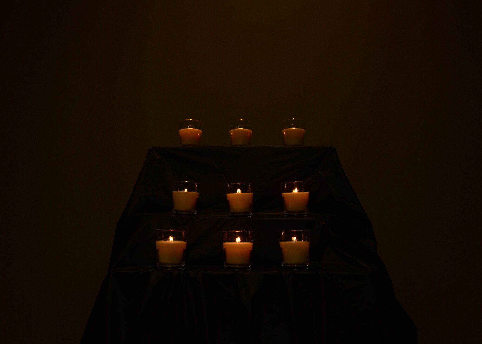 Candles are displayed during a Holocaust remembrance ceremony at Shaw Air Force Base, S.C., April 27, 2017. The candles were individually lit as volunteers read Holocaust victims accounts, signifying their spirits and journeys. (U.S. Air Force photo by Airman 1st Class Kathryn R.C. Reaves)
