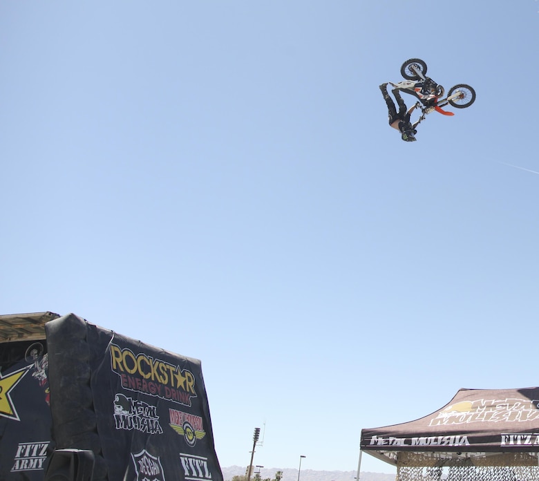 Cal Vallone, professional freestyle motocross rider, performs a trick during the Provost Marshal’s Office annual Community Safety Event at Victory Field aboard Marine Corps Air Ground Combat Center, Twentynine Palms, Calif., April 21, 2017. PMO hosted the event to educate the community on various programs and strengthen community based partnerships. (U.S. Marine photo by Lance Cpl. Natalia Cuevas)