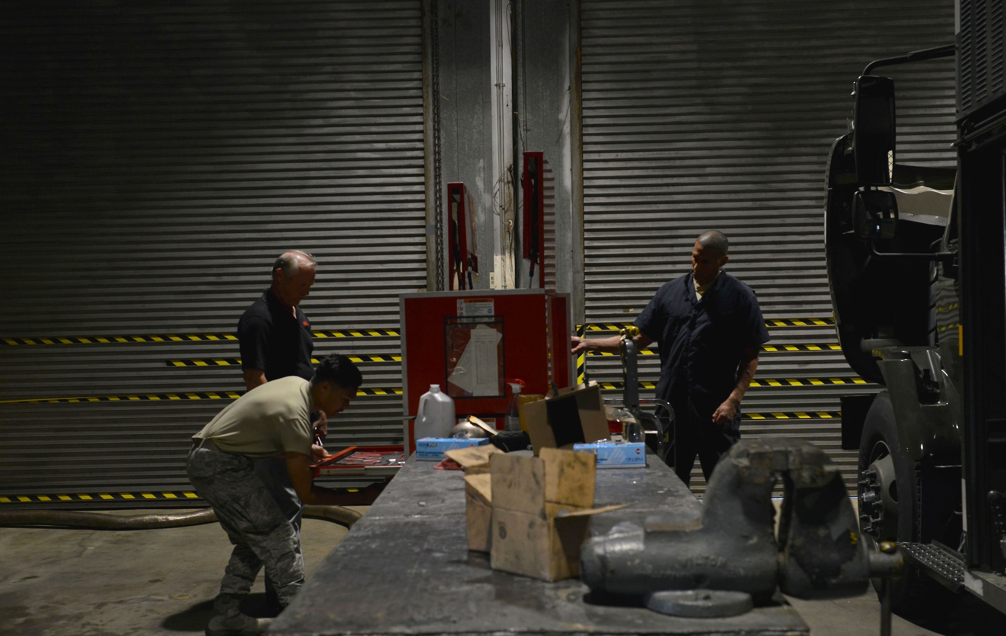 U.S. Air Force Airman 1st Class Yves Xavier Yap, 20th Logistics Readiness Squadron (LRS) fire truck and refueling maintainer, front left, Milton Kyle, 20th LRS refueling vehicle mechanic, back left, and Tech. Sgt. Dwain Burton, 20th LRS refueling maintenance noncommissioned officer in charge, gather tools to use on an R-11 refueling truck at Shaw Air Force Base, S.C., April 27, 2017. The three are part of the refueling maintenance flight and are responsible for 19 vehicles used to fuel F-16CM Fighting Falcons. (U.S. Air Force photo by Airman 1st Class Destinee Sweeney)