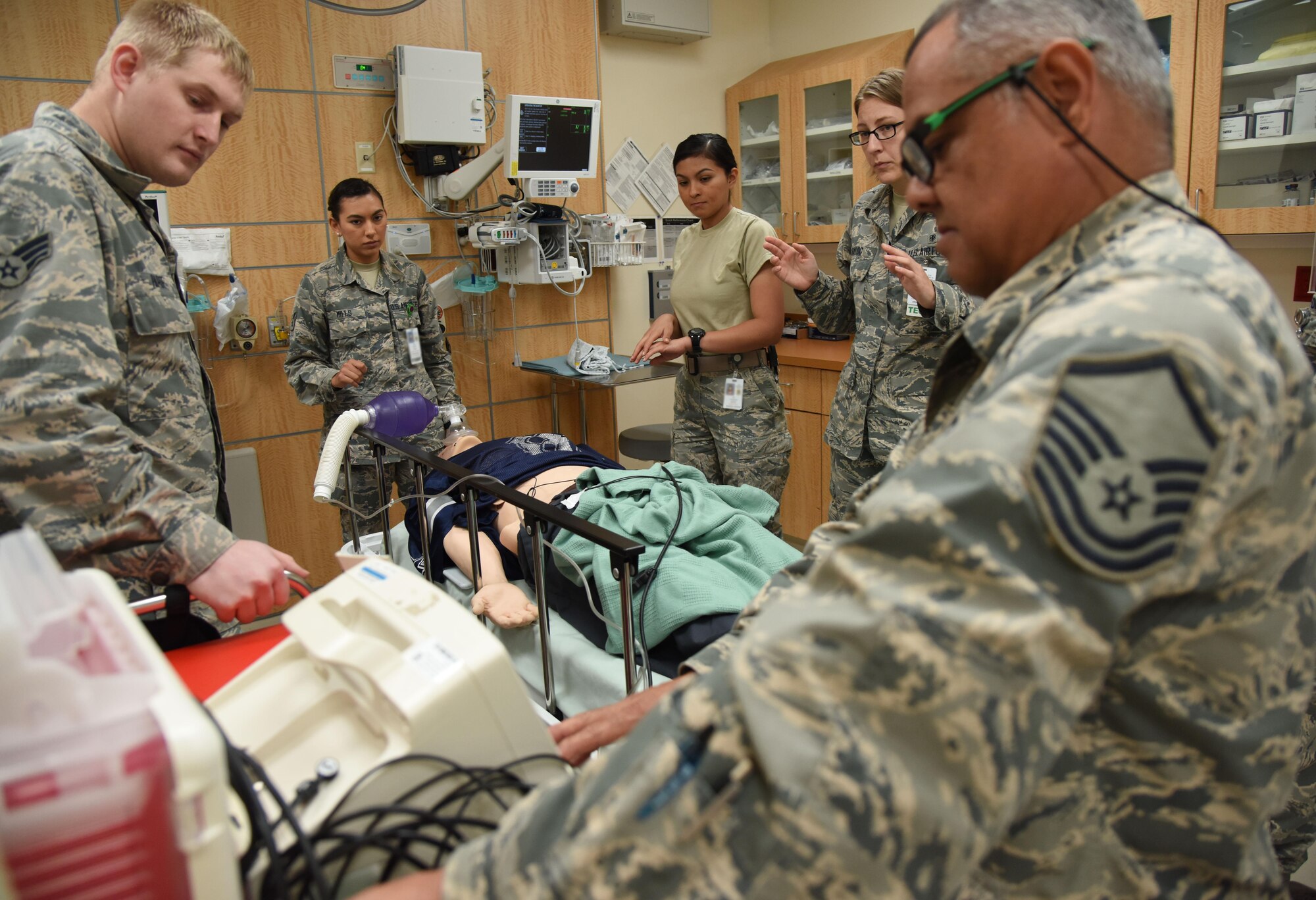 Members of the 81st Medical Operations Squadron simulate administering shock treatment to a “patient” during Code Blue Thursday in the Keesler Medical Center emergency room April 27, 2017, on Keesler Air Force Base, Miss. Emergency Room staff members coordinated with the simulation lab to use human patient simulators for running various advanced cardiac life support scenarios to improve Keesler’s new medical technicians’ skills and get them familiar with emergency equipment. (U.S. Air Force photo by Kemberly Groue)