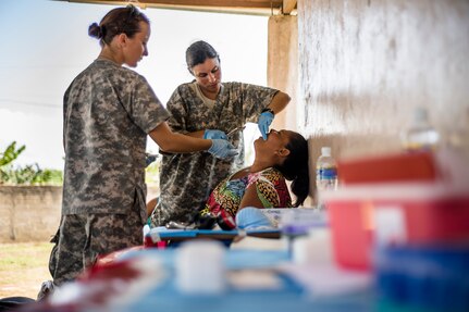 U.S. Army Maj. Anabel Curiel extracts a tooth from a Honduran patient with Sgt. Charissa Youngs at a Medical Readiness Training Exercise site at Cooperativa village, Colon, Honduras , Apr. 21, 2017. Joint Task Force – Bravo Medical Element, provided care to more than 850 patients during a Medical Readiness Training Exercise in Cooperativa village, Colon, Honduras, Apr. 20-21, 2017. MEDEL also supported a Military Partnership Engagement and assisted more than 650 patients with the Hondurian Navy in Santa Rosa de Aguan, Colon, Honduras, Apr. 22, 2017. (U.S. Air National Guard photo by Master Sgt. Scott Thompson/released)