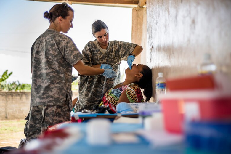 U.S. Army Maj. Anabel Curiel extracts a tooth from a Honduran patient with Sgt. Charissa Youngs at a Medical Readiness Training Exercise site at Cooperativa village, Colon, Honduras , Apr. 21, 2017. Joint Task Force – Bravo Medical Element, provided care to more than 850 patients during a Medical Readiness Training Exercise in Cooperativa village, Colon, Honduras, Apr. 20-21, 2017. MEDEL also supported a Military Partnership Engagement and assisted more than 650 patients with the Hondurian Navy in Santa Rosa de Aguan, Colon, Honduras, Apr. 22, 2017. (U.S. Air National Guard photo by Master Sgt. Scott Thompson/released)
