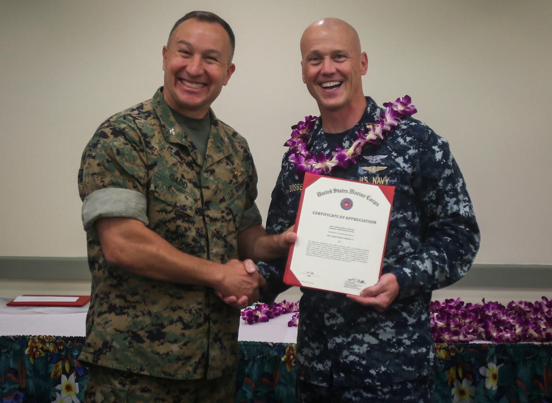 Col. Peter Gadd, the commanding officer of Headquarters and Service Battalion of Marine Corps Forces Pacific, and Senior Chief Petty Officer Lonnie Bussell, the command senior chief of Fleet Logistics Support Squadron 51, pose for a photo during a volunteer recognition ceremony at the Staff Noncommissioned Officer Club ballroom aboard Marine Corps Base Hawaii on April 27, 2017. The ceremony was dedicated to recognizing the community volunteer efforts of each unit stationed in MCB Hawaii.