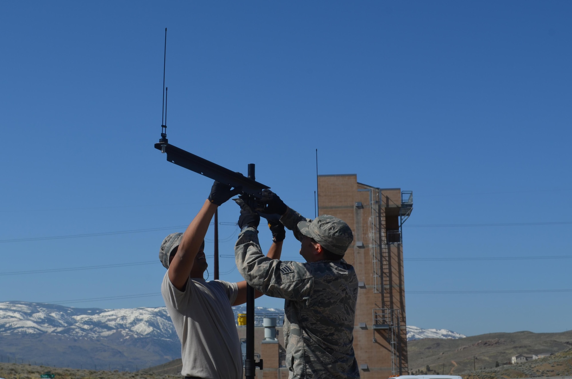 Two Nevada Air National Guard Joint Incident Site Communications Capability (JISCC) members, Senior Airman David Almada (right) and Staff Sgt. Jesse Lemos assemble an antenna mast at the Regional Public Safety Training Center in Reno, Nevada, during the 2017 practice exercise. The team, along with the Nevada Air National Guard’s CBRNE (Chemical, Biological, Radiological, Nuclear and High Yield Explosive) Enhanced Response Force Package (CERFP) will have their annual ExEval inspection in June.