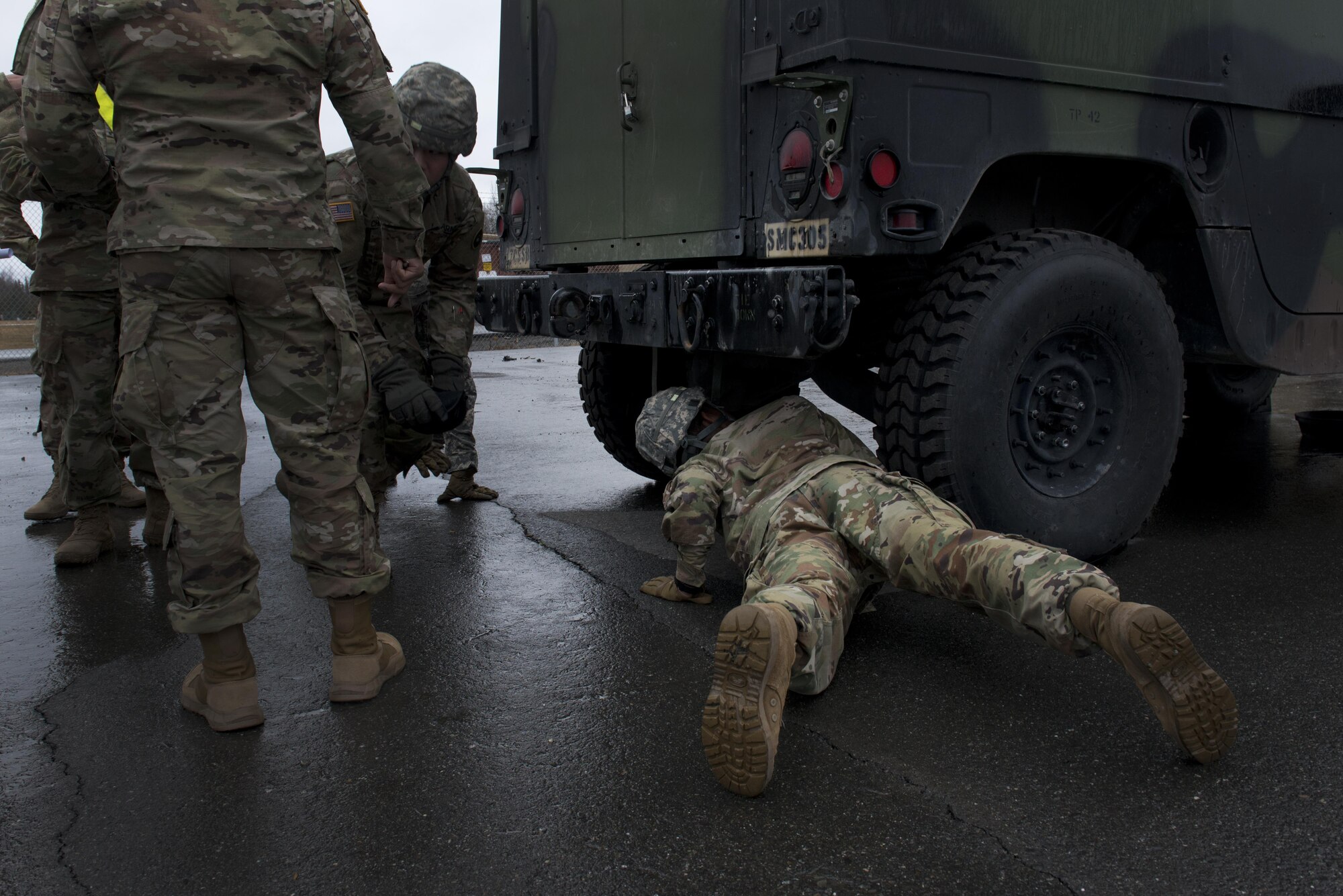 Private Second Class Jeffrey Vargas, 98th Maintenance Company, 17th Combat Sustainment Support Battalion checks the undercarriage of a Humvee April 27 at the 98th MC motorpool on Joint Base Elmendorf-Richardson. Vargas was the first in his platoon to check the undercarriage of the vehicle during the 98th MC's maintenance rodeo. 