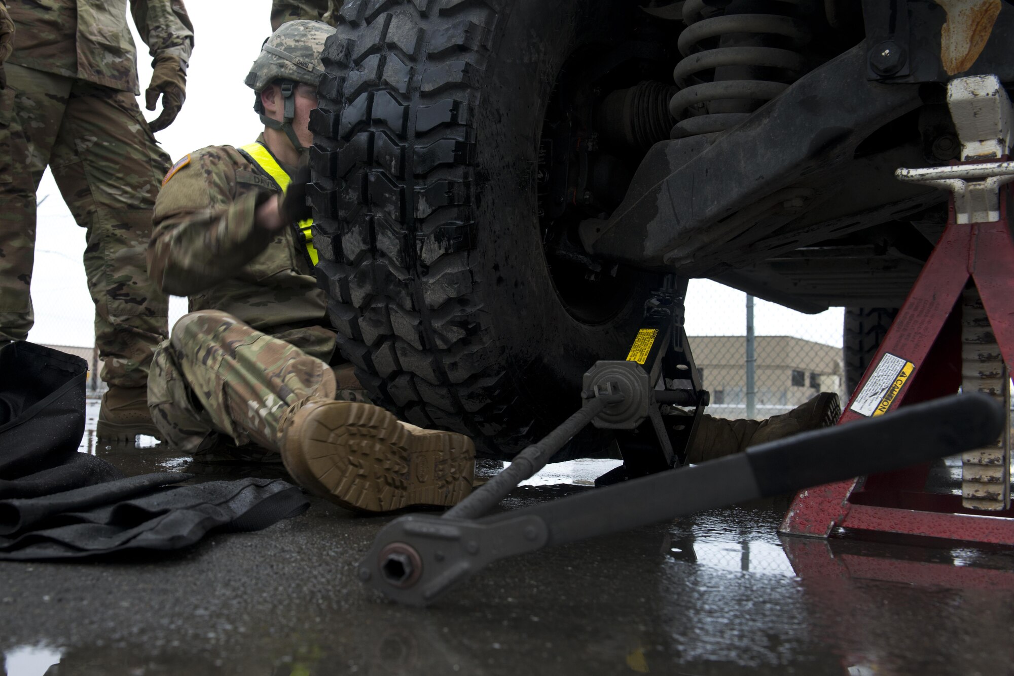 Pfc. Anthony Davis, assigned to the 98th Maintenance Company, 17th Combat Sustainment Support Battalion changes the tire on a humvee as he competes in the 98th MC's maintenance rodeo April 27. The Rodeo is designed to sharpen their professional skill sets and their interpersonal relationships to create a stronger unit. 