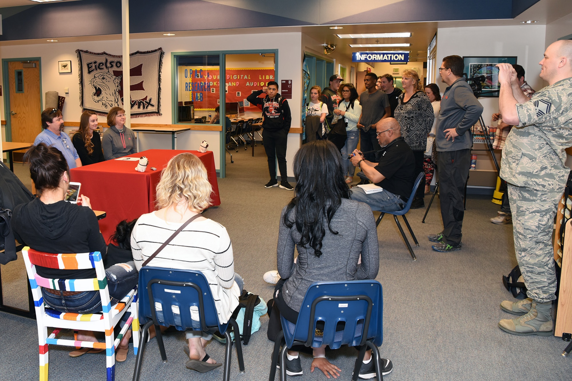 Friends, teachers, and team mates of Emily Donovan, daughter of Senior Master Sgt. Rebecca Donovan, 168th Force Development superintendent, Alaska Air National Guard, gathered inside the Ben Eielson High School library, April 27, 2017, Eielson AFB, Alaska, to show their support as Emily signed her college letter of intent. Donovan, graduating next month from Eielson, will be playing college volleyball in Tennessee and will study exercise science and sports psychology. (U.S. Air National Guard photo by Senior Master Sgt. Paul Mann/Released)