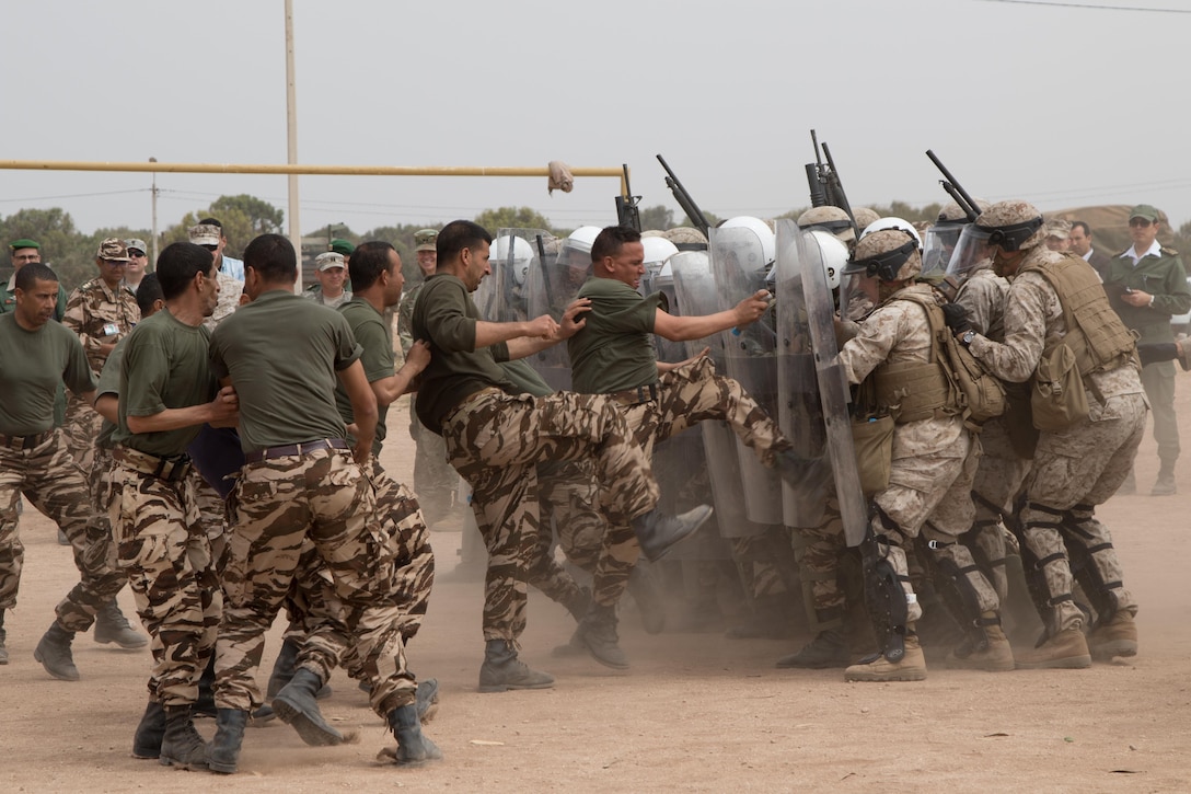 U.S. Soldiers with the 805th Military Police Company, Marines from Marine Company B, 4th Law Enforcement Battalion, and Royal Moroccan Armed Forces defend against rioters during crowd control training at Tifnit, Morocco, on April 24, 2017, during Exercise African Lion. Exercise African Lion is an annually scheduled, combined multilateral exercise designed to improve interoperability and mutual understanding of each nation’s tactics, techniques and procedures.