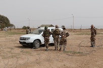 A U.S. Soldier, Marine, and two Moroccan soldiers prepare to search a vehicle in a training vehicle check point in Tifnit, Morocco, on April 22, 2017, during Exercise African Lion. Exercise African Lion is an annually scheduled, combined multilateral exercise designed to improve interoperability and mutual understanding of each nation’s tactics, techniques and procedures.