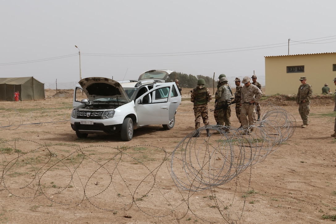 A U.S. Soldier, Marine, and two Moroccan soldiers search a vehicle in a training vehicle check point in Tifnit, Morocco, on April 22, 2017, during Exercise African Lion. Exercise African Lion is an annually scheduled, combined multilateral exercise designed to improve interoperability and mutual understanding of each nation’s tactics, techniques and procedures.