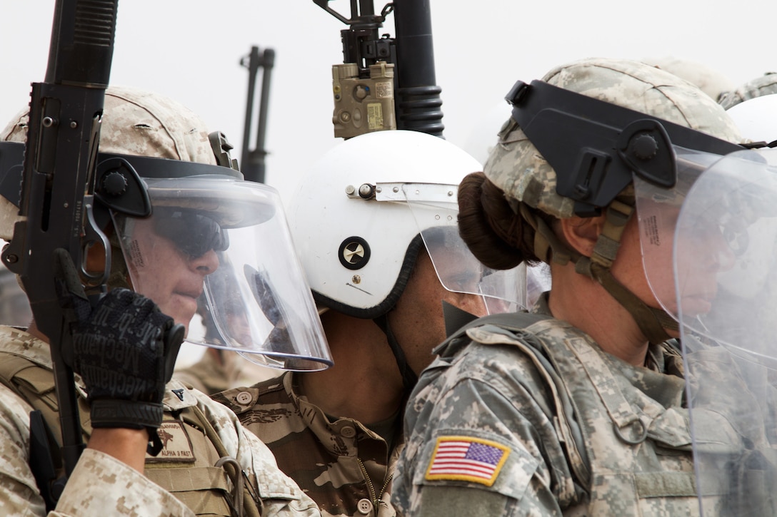 U.S. Soldiers representing the 805th Military Police Company from Cary N.C. and Marines with Alpha 3rd Marine Fleet Antiterrorism Security Team participate in crowd control training with Royal Moroccan Armed Forces during Exercise African Lion April 23, at Tifnit, Morocco. During training U.S. military shared training equipment with Moroccan soldiers. African Lion is an annually scheduled, combined multilateral exercise designed to improve interoperability and mutual understanding of each nation’s tactics, techniques and procedures.
