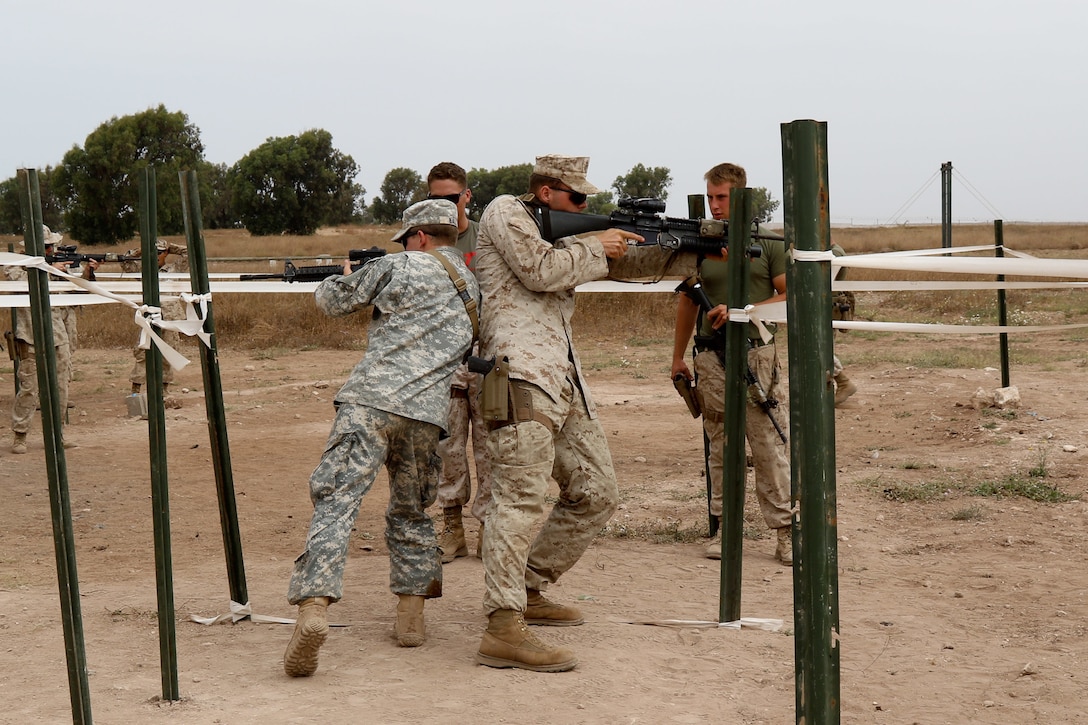 U.S. Soldier and Marine representing the 805th Military Police Company and the Alpha 3rd Marine Fleet Antiterrorism Security Team, complete T-shaped hall clearing training during Operation African Lion April 24, at Tifnit, Morocco. Exercise African Lion is annually scheduled, combined multilateral exercise designed to improve interoperability and mutual understanding of each nation’s tactics, techniques and procedures. 