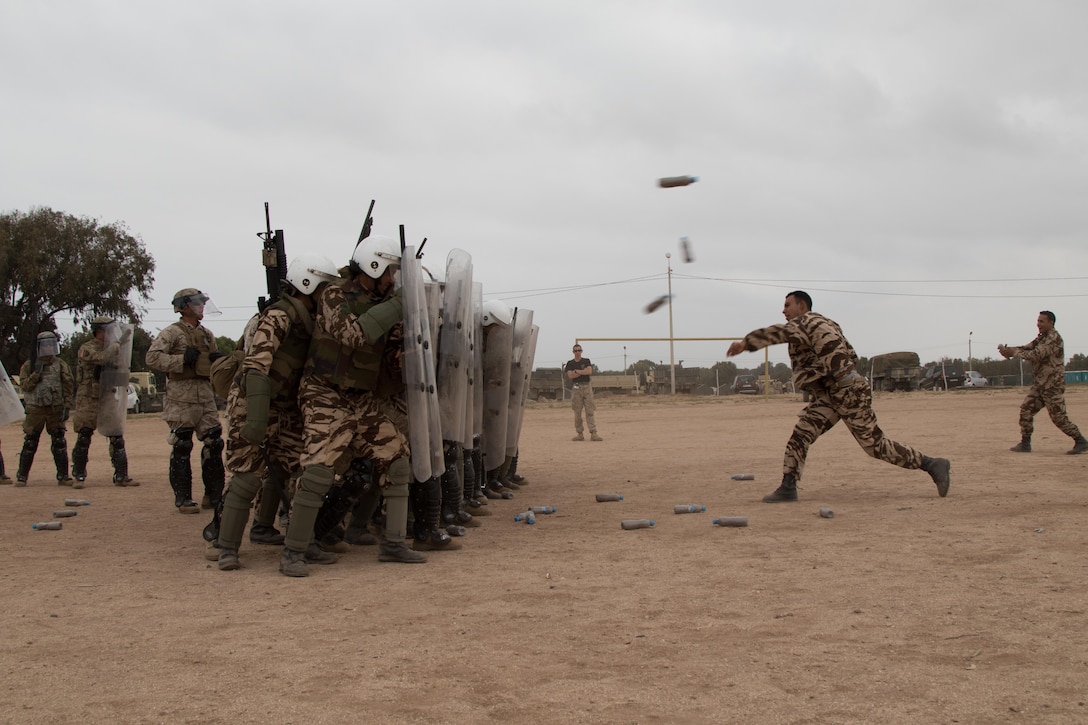 Military police with the 805th MP company from Cary, North Carolina, Marines with Marine Company B, 4th Law Enforcement Battalion, and Royal Moroccan Armed Forces defend against rioters during crowd control training in Tifnit, Morocco, on April 24, 2017, during Exercise African Lion. Exercise African Lion is an annually scheduled, combined multilateral exercise designed to improve interoperability and mutual understanding of each nation’s tactics, techniques and procedures.