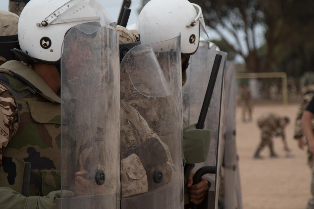 U.S. Soldiers with the 805th Military Police Company, Marines from Marine Company B, 4th Law Enforcement Battalion, and Royal Moroccan Armed Forces stand ready to defend against rioters during crowd control training in Tifnit, Morocco, on April 24, 2017, during Exercise African Lion. Exercise African Lion is an annually scheduled, combined multilateral exercise designed to improve interoperability and mutual understanding of each nation’s tactics, techniques and procedures.