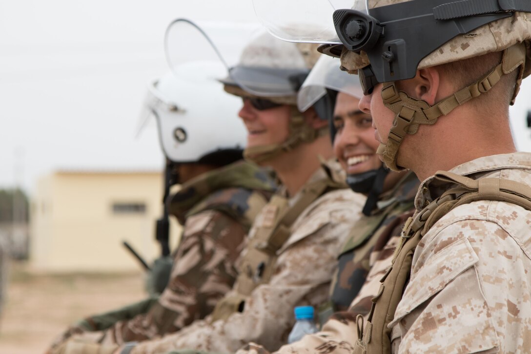 Marine Company B, 4th Law Enforcement Battalion from Pittsburg, Pennsylvania, and Royal Moroccan Armed Forces enjoy a small break in crowd control training in Tifnit, Morocco, on April 24, 2017, during Exercise African Lion. Exercise African Lion is an annually scheduled, combined multilateral exercise designed to improve interoperability and mutual understanding of each nation’s tactics, techniques and procedures.