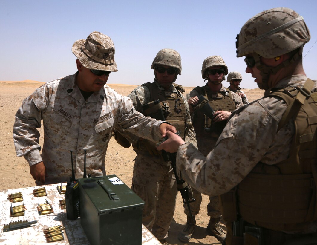 U.S. Marine Corps Gunnery Sgt. Pedro Juarez, an engineer equipment chief with Marine Wing Support Squadron 372, Special Purpose Marine Air-Ground Task Force-Crisis Response-Central Command, distributes ammunition to Marines during a battle sight zero range while forward deployed to the Middle East, April 23, 2017. The training was conducted to ensure SPMAGTF Marines are prepared to react and respond to a variety of scenarios that may occur across the USCENTCOM area of operations. SPMAGTF-CR-CC is a well-trained crisis response unit that has the ability to project combat power over vast distances using organic aviation, logistical, and ground combat assets.  (U.S. Marine Corps photo by Lance Cpl. Joshua S. McAlpine)