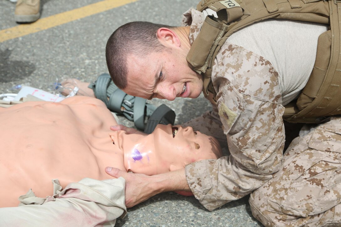 U.S. Navy L¬t. j.g. Stephen Lancaster, a hospital nurse with the Shock Trauma Platoon, Special Purpose Marine Air-Ground Task Force-Crisis Response-Central Command, demonstrates the proper head holding techniques on a simulated patient during a casualty evacuation exercise while forward deployed in the Middle East, April 19, 2017. Being able to quickly and efficiently treat wounded personnel on the move while utilizing organic aviation assets supports the SPMAGTF’s vast crisis response capability. (U.S. Marine Corps photo by Lance Cpl. Joshua McAlpine)