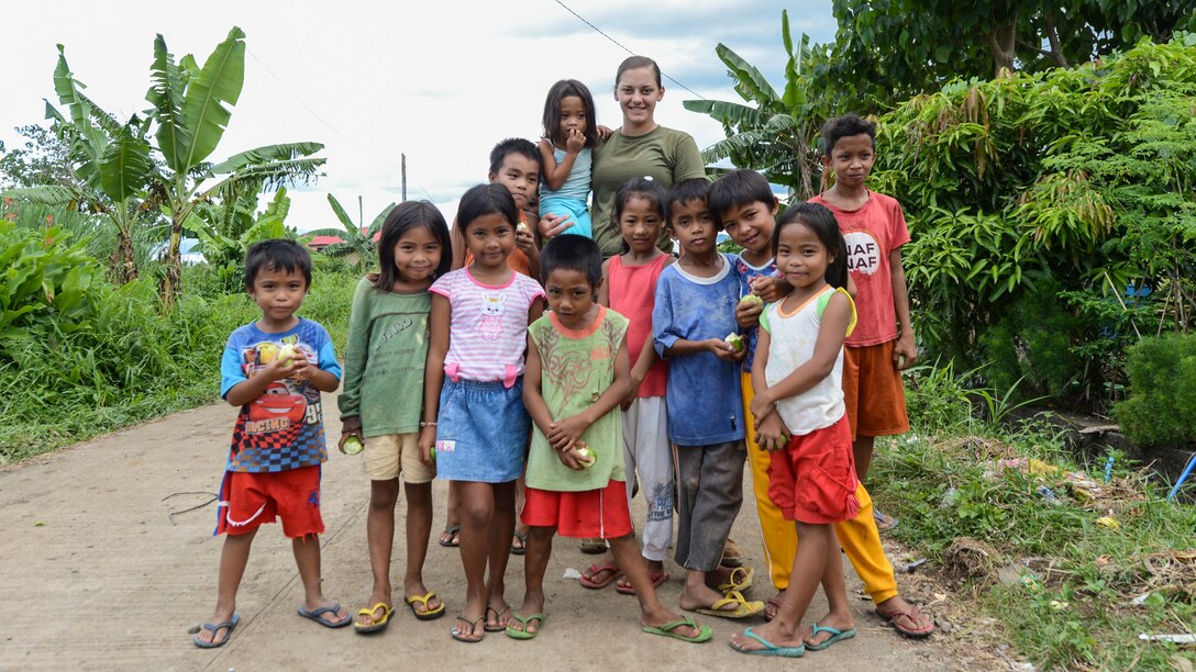 U.S. Marine Lance Cpl. Brook Klahn with 9th Engineer Support Battalion poses for a group photo with the local kids during Balikatan 2017 in Ormoc City, Leyte, April 24, 2017. Armed Forces of the Philippines along with U.S. military engineers worked together to build a new classroom at Don Carlos Elementary School in Ormoc City. Balikatan is an annual U.S.-Philippine military bilateral exercise focused on a variety of missions, including humanitarian assistance and disaster relief and counterterrorism. The increased interoperability will enhance readiness of humanitarian assistance and disaster relief capabilities. 