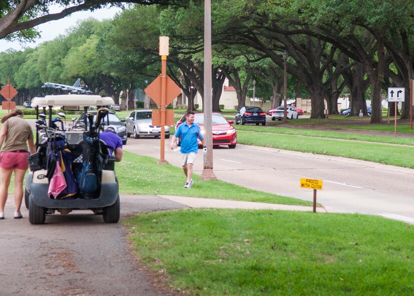 Lt. Col. Shawn Werchan, the commander of the 307th Operations Support Squadron, stops traffic to retrieve his ball after a shot ended up in the street during the 307th Bomb Wing Family Day golf tournament at Barksdale Air Force Base, La., April 29, 2017. Golf is one of many events hosted at the annual Family Day for Airmen and their families. Other events included basketball, horseshoes, archery and bowling along with barbecue, fun jumps and a vintage car show.  (U.S. Air Force photo by Tech. Sgt. Cody Burt/Released)