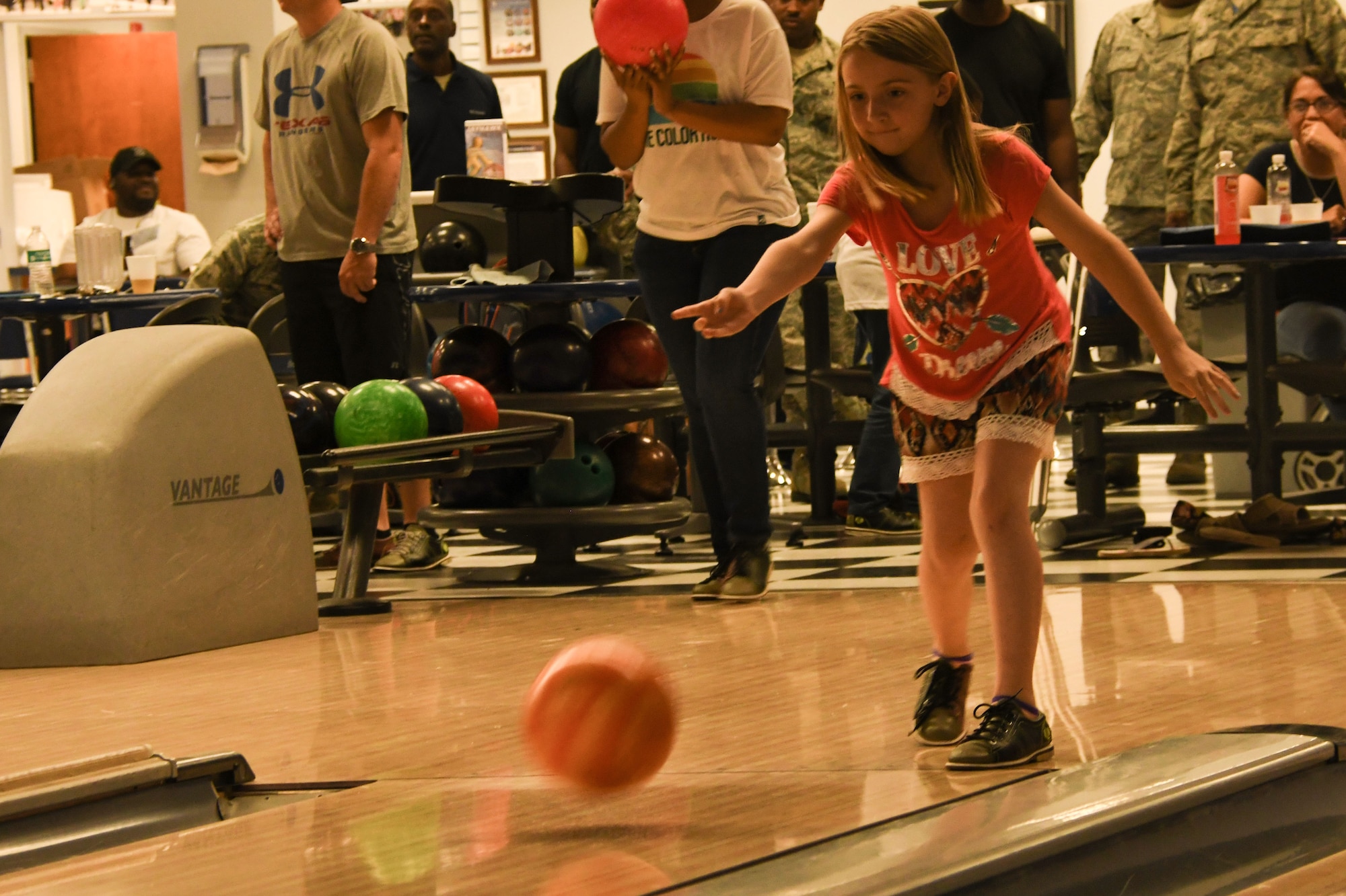 Makayla Johns sends a bowling ball down the lane during 307th Bomb Wing Family Fun Day at Barksdale Air Force Base, La., April 29, 2017.  She was one of several family members participating in a wide range of events.   Family Fun Day is hosted annually in gratitude for the many sacrifices made by wing members and their families.  (U.S. Air Force photo by Tech. Sgt. Ted Daigle/Released)