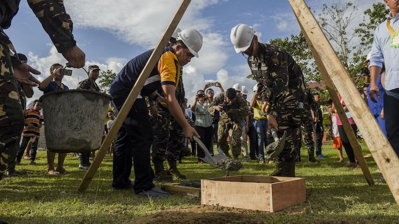 Leaders from the Armed Forces of the Philippines and city officials bury a time capsule during a groundbreaking ceremony for Balikatan 2017 in Ormoc City, Leyte, April 25, 2017. Leaders from the Armed Forces of the Philippines, U.S. military, and Ormoc City gathered to commemorate the beginning of engineering projects for new classrooms at Margen Elementary School in Ormoc City. Balikatan is an annual U.S.-Philippine military bilateral exercise focused on a variety of missions, including humanitarian assistance and disaster relief and counterterrorism. 