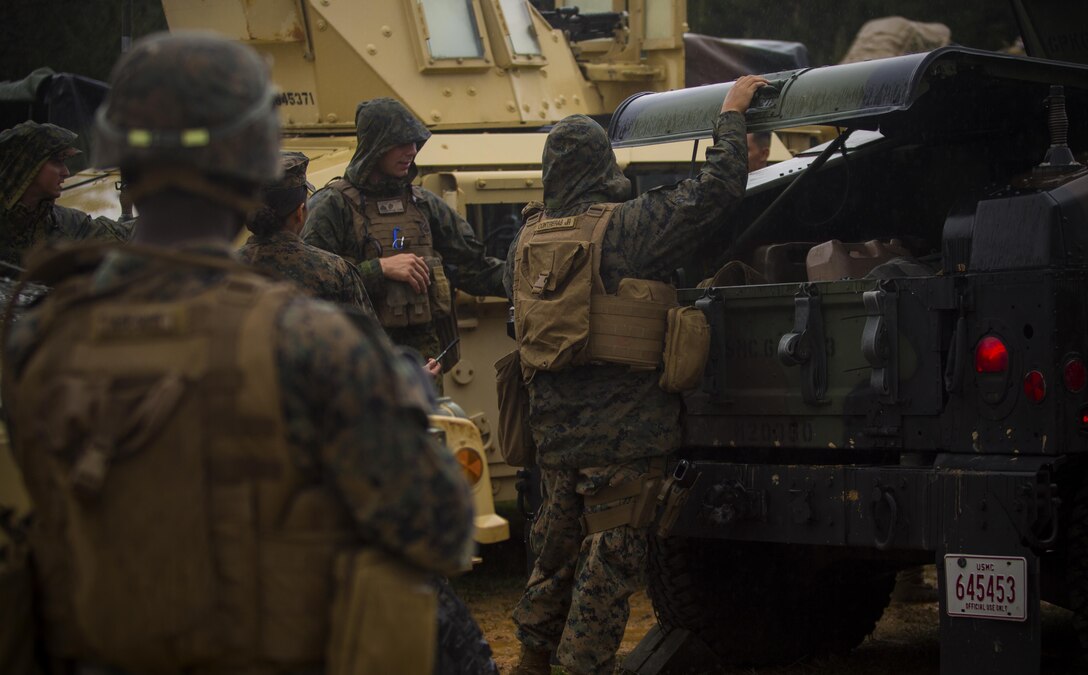 Marines load gear for a mounted patrol at Central Training Area, Camp Hansen, Okinawa, Japan, April 18, 2017. 3d Law Enforcement battalion conducted a Marine Corps Combat Readiness Evaluation to test each company’s ability to execute tasks ranging from policing operations to police patrolling, route regulations, key leader engagements in towns and local population centers, security of key infrastructure, identity operations and law enforcement operations in an expeditionary environment to ensure they are prepared to support the operational requirements of III Marine Expeditionary Force. The Marines are with Charlie Company, 3d LE Bn, III MEF Headquarters Group. (U.S. Marine Corps photo by Lance Cpl. Joshua Pinkney)