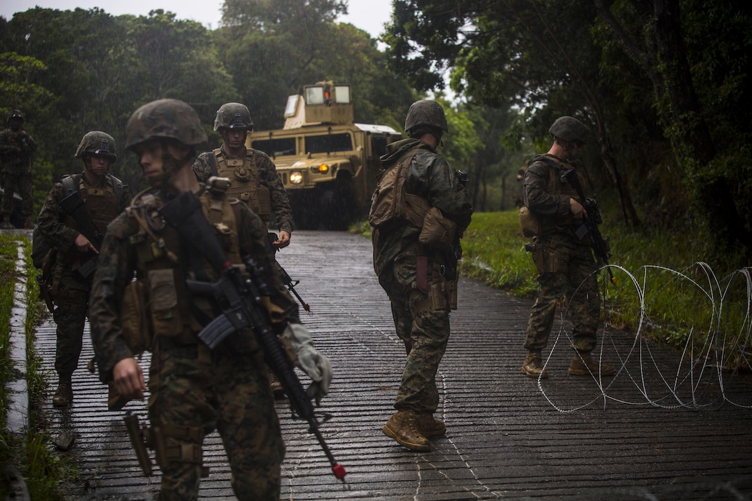 Marines set up a vehicle control point at Central Training Area, Camp Hansen, Okinawa, Japan, April 18, 2017. 3d Law Enforcement battalion conducted a Marine Corps Combat Readiness Evaluation to test each company’s ability to execute tasks ranging from policing operations to police patrolling, route regulations, key leader engagements in towns and local population centers, security of key infrastructure, identity operations and law enforcement operations in an expeditionary environment to ensure they are prepared to support the operational requirements of III Marine Expeditionary Force. The Marines are with Bravo Company, 3d LE Bn, III MEF Headquarters Group. (U.S. Marine Corps photo by Lance Cpl. Joshua Pinkney)