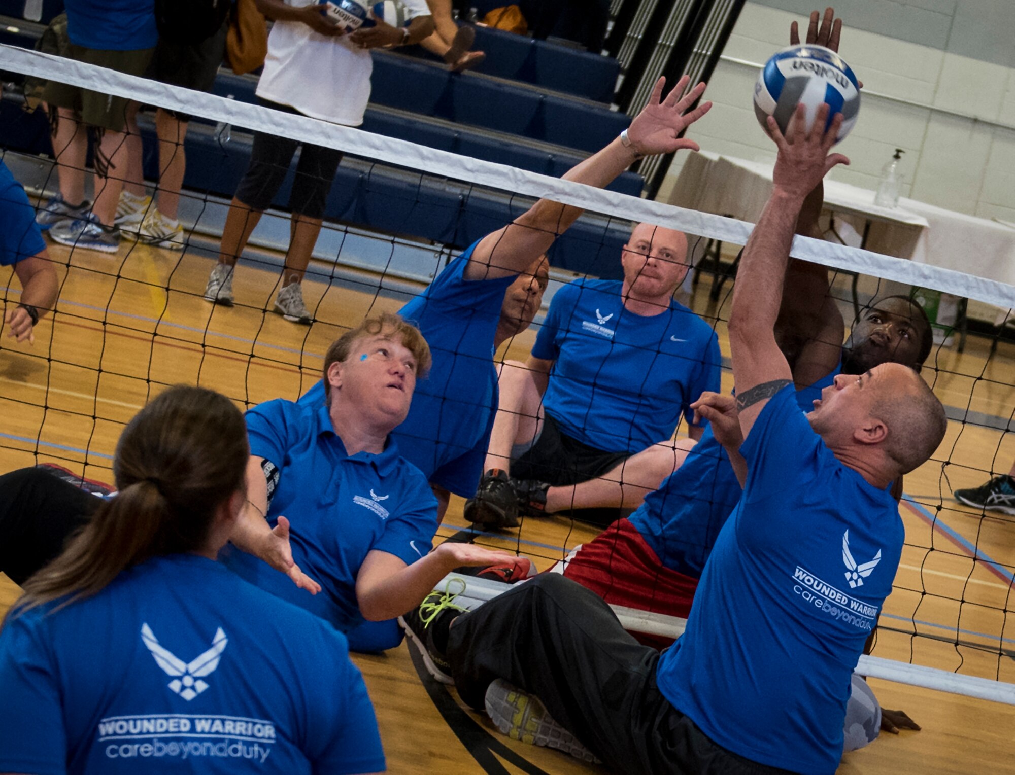 Air Force Warrior CARE athletes compete in a sitting volleyball scrimmage game during the last day of the adaptive sports camp at Eglin Air Force Base, Fla., April 28. The base hosts the week-long Wound Warrior CARE event that helps recovering wounded, ill and injured military members through specific hand-on rehabilitative training. (U.S. Air Force photo/Samuel King Jr.)