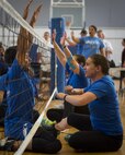 Keith Guinn, a Warrior Games athlete, tries squares off against Sarah Ziaja, a Warrior CARE athlete, during a sitting volleyball scrimmage match at Eglin Air Force Base, Fla., April 28. The base hosts the week-long Wound Warrior CARE event that helps recovering wounded, ill and injured military members through specific hand-on rehabilitative training. (U.S. Air Force photo/Samuel King Jr.)
