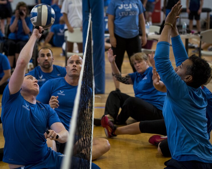 Austin Williamson, an Air Force Warrior Games athlete, sets up his teammate during a sitting volleyball scrimmage game on the final day of a training camp held at Eglin Air Force Base, Fla., April 28. The base-hosted, week-long Warrior Games training camp is the last team practice session before the yearly competition in June. (U.S. Air Force photo/Samuel King Jr.)