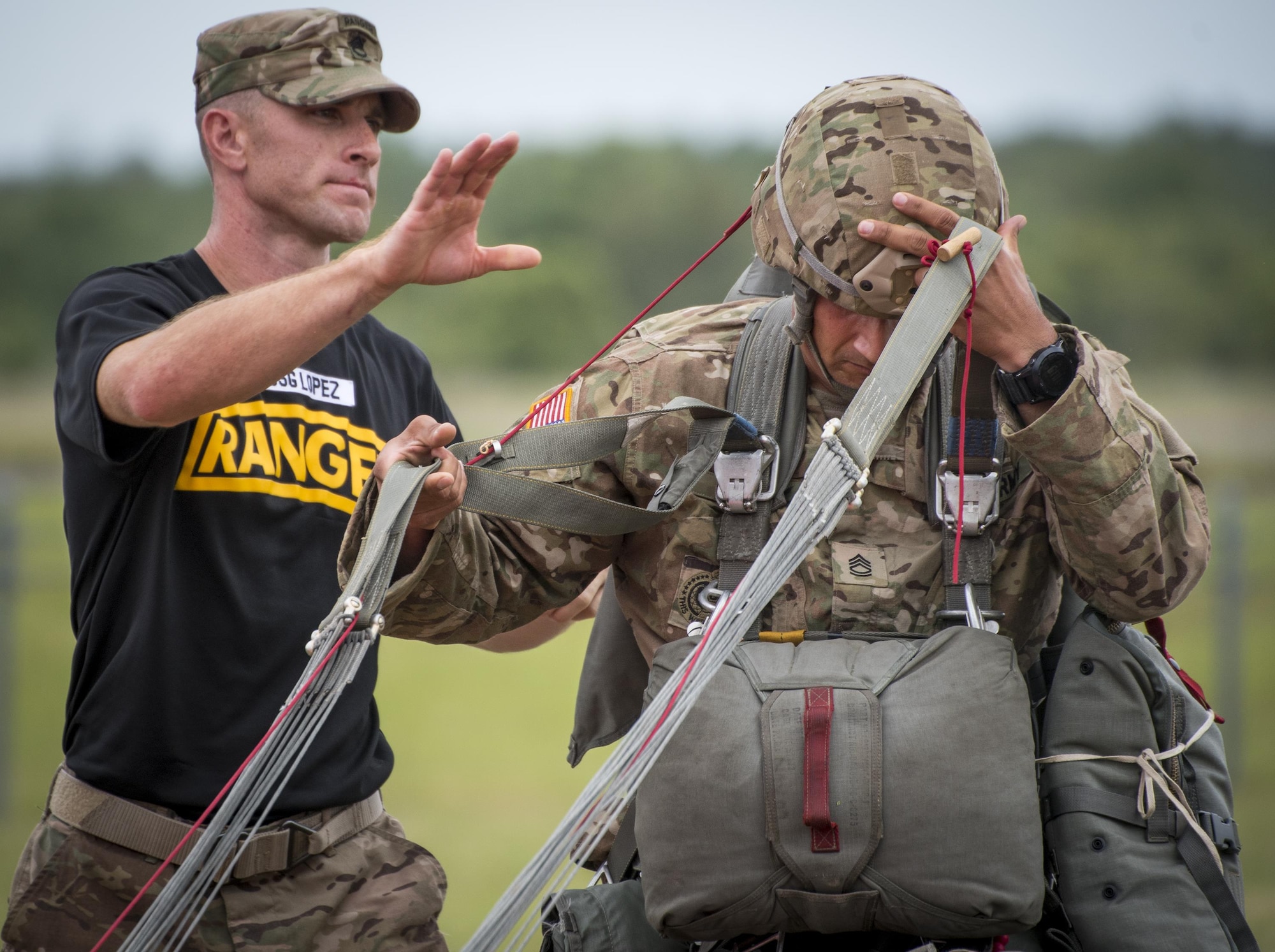 Soldiers demonstrate parachute techniques during the 6th Ranger Training Battalion’s open house event April 29 at Eglin Air Force Base, Fla. The event was a chance for the public to learn how Rangers train and operate. The event displays showed equipment, weapons, a reptile zoo, face painting and weapon firing among others. The demonstrations showed off hand-to-hand combat, a parachute jump, snake show, and Rangers in action. (U.S. Air Force photo/Samuel King Jr.)