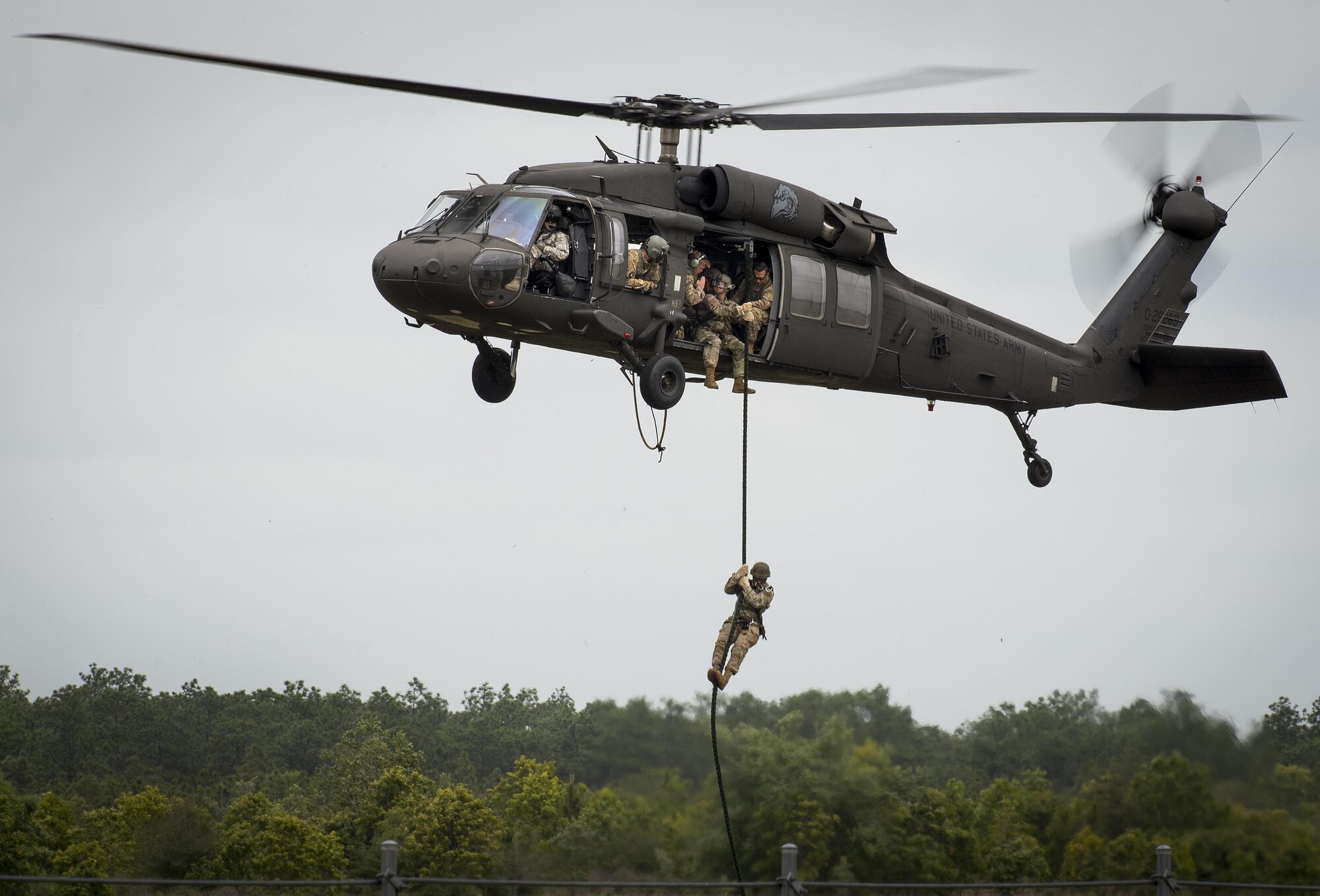 A Soldier exits a Blackhawk helicopter via a rope during a demonstration at the 6th Ranger Training Battalion’s open house event April 29 at Eglin Air Force Base, Fla. The event was a chance for the public to learn how Rangers train and operate. The event displays showed equipment, weapons, a reptile zoo, face painting and weapon firing among others. The demonstrations showed off hand-to-hand combat, a parachute jump, snake show, and Rangers in action. (U.S. Air Force photo/Samuel King Jr.)