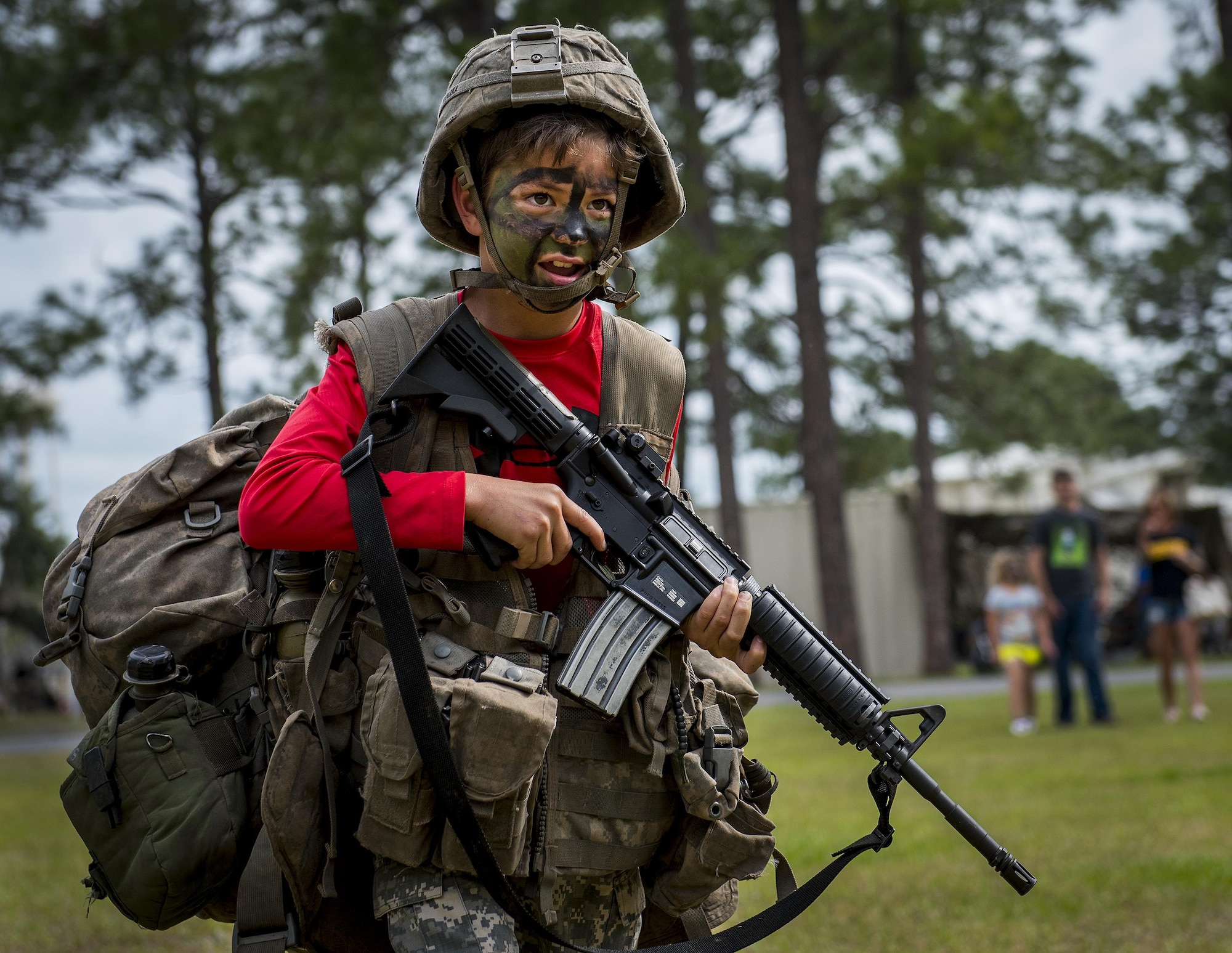 A future Soldier struggles to carry all the equipment and gear required for a Ranger during the 6th Ranger Training Battalion’s open house event April 29 at Eglin Air Force Base, Fla. The event was a chance for the public to learn how Rangers train and operate. The event displays showed equipment, weapons, a reptile zoo, face painting and weapon firing among others. The demonstrations showed off hand-to-hand combat, a parachute jump, snake show, and Rangers in action. (U.S. Air Force photo/Samuel King Jr.)