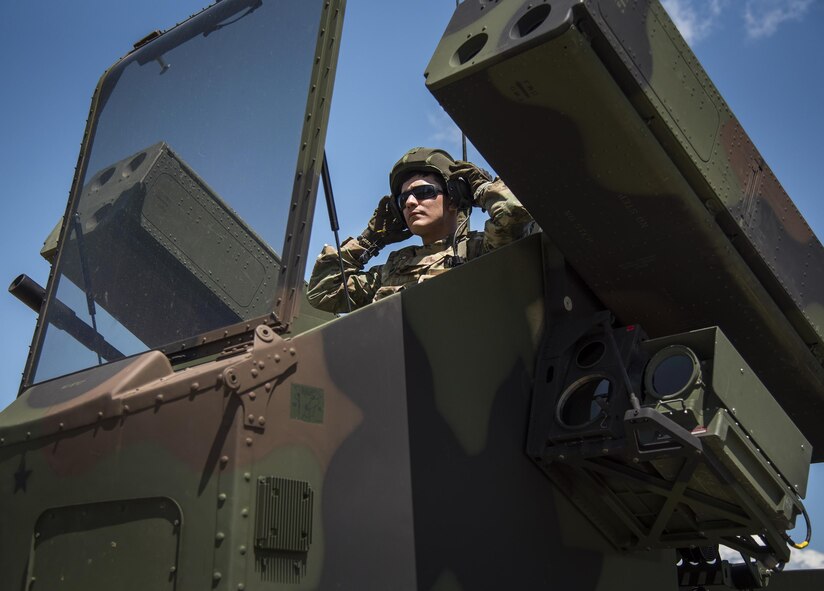 Spc. Christopher Bazan, Florida National Guard 3rd Battalion, 265 Air Defense Artillery Regiment, puts on his helmet before closing the canopy on the Avenger’s turret April 20.  The unit along with the Army’s Stinger Based Systems used the Eglin Air Force Base range to test fire stinger missiles from the vehicle. (U.S. Air Force photo/Samuel King Jr.)