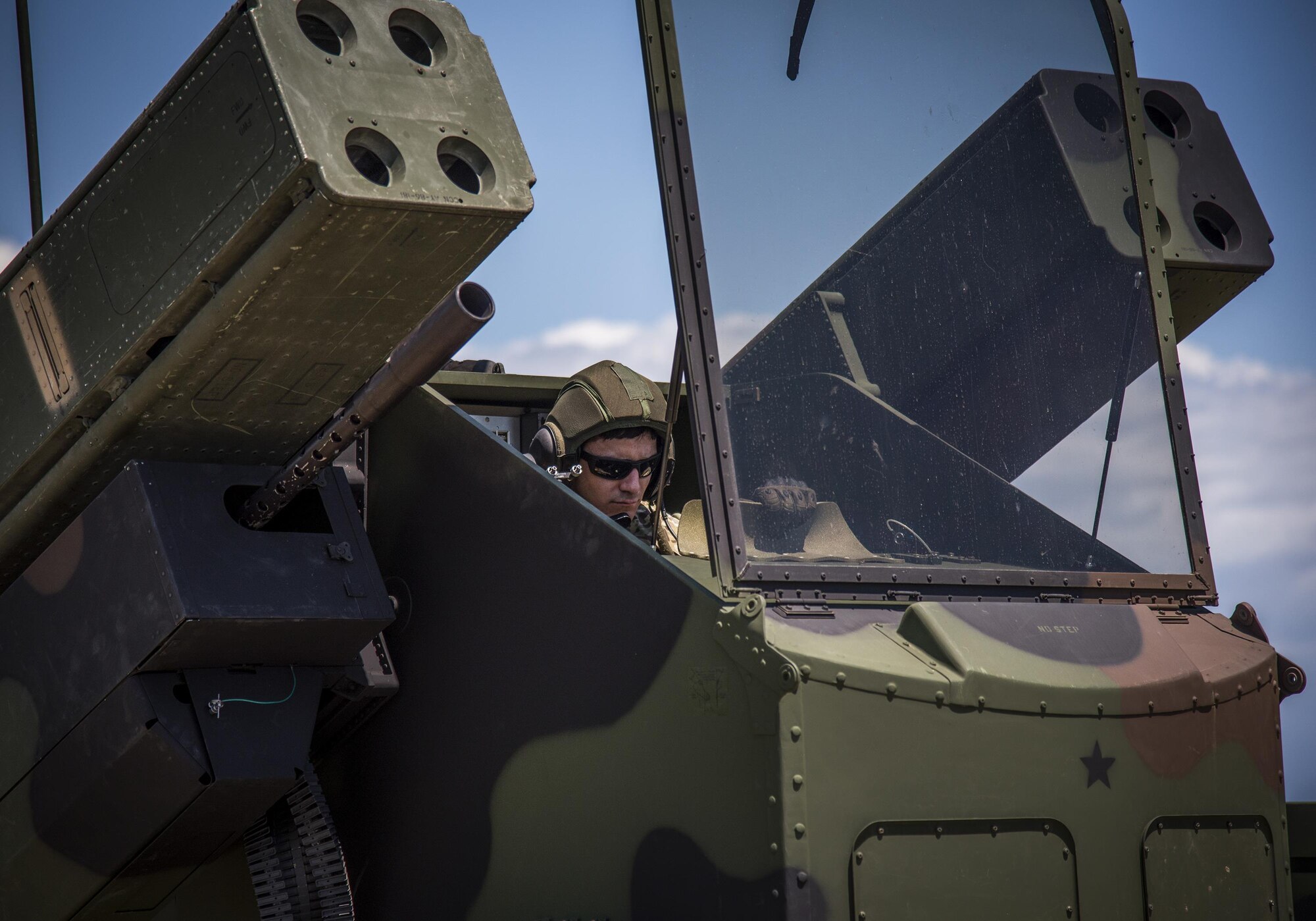 Spc. Christopher Bazan, Florida National Guard 3rd Battalion, 265 Air Defense Artillery Regiment, checks weapon settings from inside the Avenger’s turret April 20.  The unit along with the Army’s Stinger Based Systems used the Eglin Air Force Base range to test fire stinger missiles from the vehicle. (U.S. Air Force photo/Samuel King Jr.)