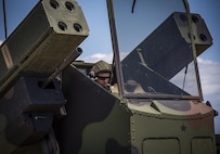 Spc. Christopher Bazan, Florida National Guard 3rd Battalion, 265 Air Defense Artillery Regiment, checks weapon settings from inside the Avenger’s turret April 20.  The unit along with the Army’s Stinger Based Systems used the Eglin Air Force Base range to test fire stinger missiles from the vehicle. (U.S. Air Force photo/Samuel King Jr.)