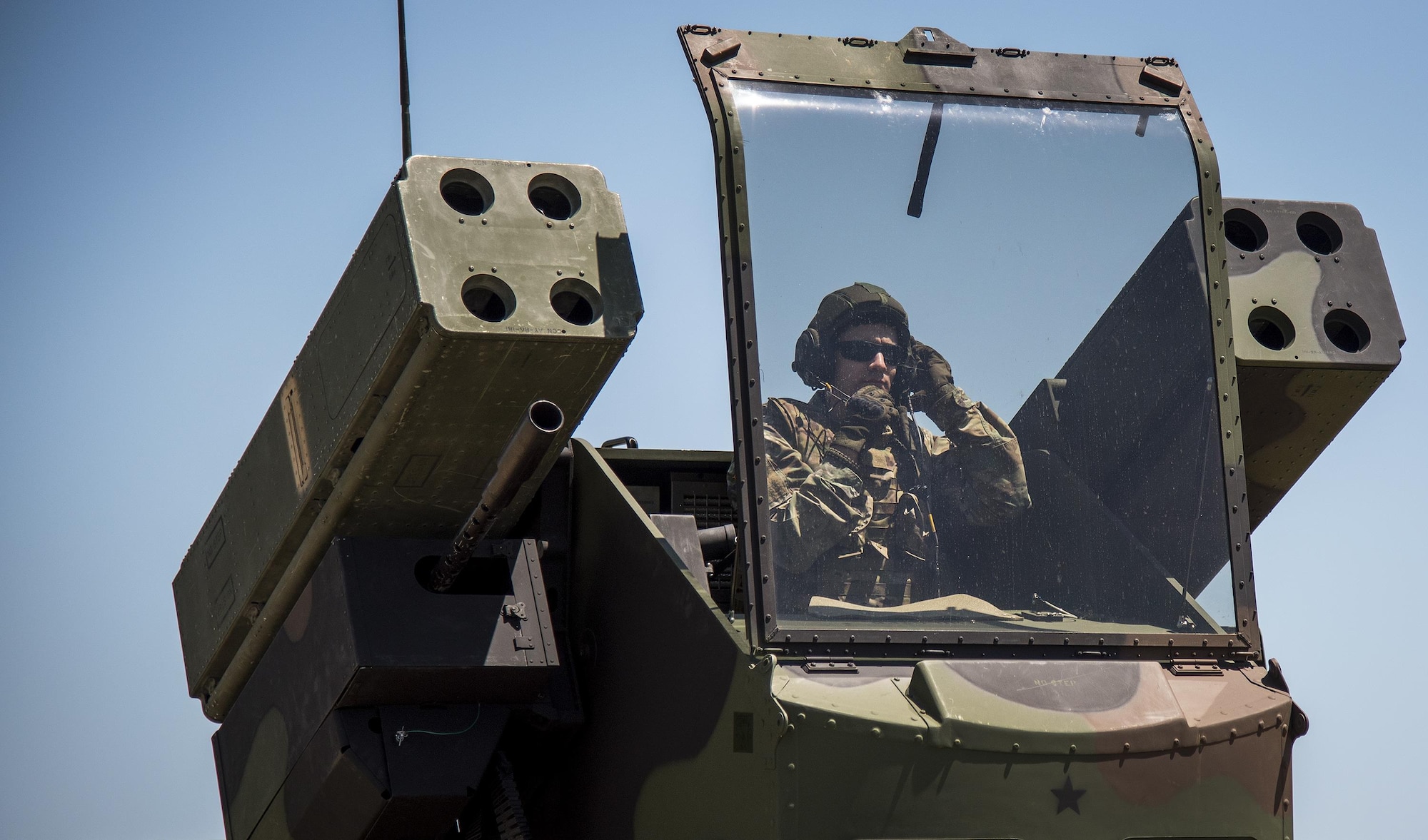 Spc. Christopher Bazan, Florida National Guard 3rd Battalion, 265 Air Defense Artillery Regiment, adjusts his helmet before closing the canopy on the Avenger’s turret April 20.  The unit along with the Army’s Stinger Based Systems used the Eglin Air Force Base range to test fire stinger missiles from the vehicle. (U.S. Air Force photo/Samuel King Jr.)
