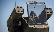 Spc. Christopher Bazan, Florida National Guard 3rd Battalion, 265 Air Defense Artillery Regiment, adjusts his helmet before closing the canopy on the Avenger’s turret April 20.  The unit along with the Army’s Stinger Based Systems used the Eglin Air Force Base range to test fire stinger missiles from the vehicle. (U.S. Air Force photo/Samuel King Jr.)