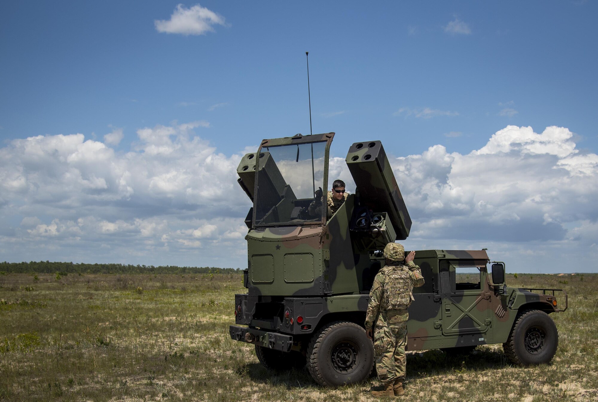 Spc. Christopher Bazan and Sgt. John Akins, Florida National Guard 3rd Battalion, 265 Air Defense Artillery Regiment, talk over their plan of action April 20.  The unit along with the Army’s Stinger Based Systems used the Eglin Air Force Base range to test fire stinger missiles from the vehicle. (U.S. Air Force photo/Samuel King Jr.)
